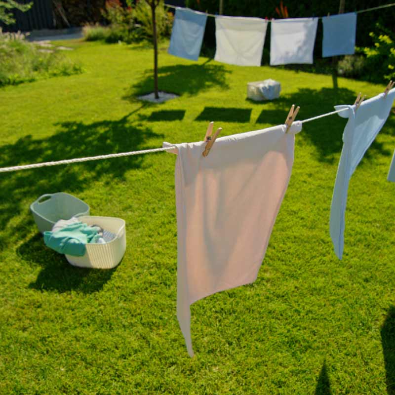Freshly washed clothes on a washing line in a garden